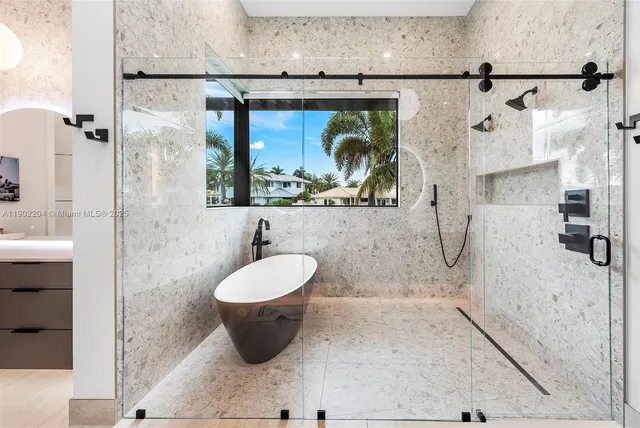a bathroom with a bathtub and a shower