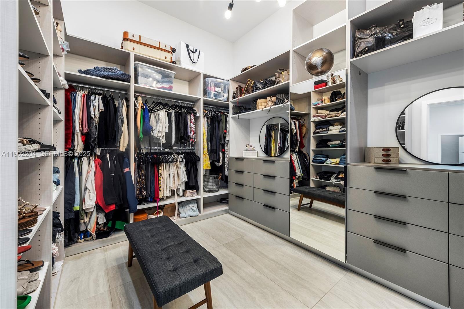 3701 Northeast 26th Avenue, Unit 1 Lighthouse Point, FL 33064 - Photo 36 of 46 a view of walk in closet with clothes and shoes