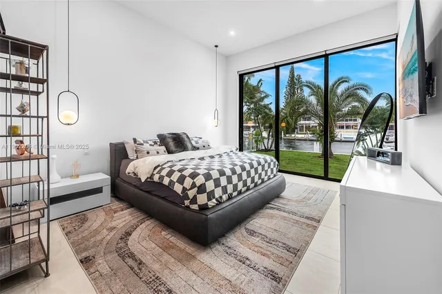 a bedroom with a large bed and a large window with outer view