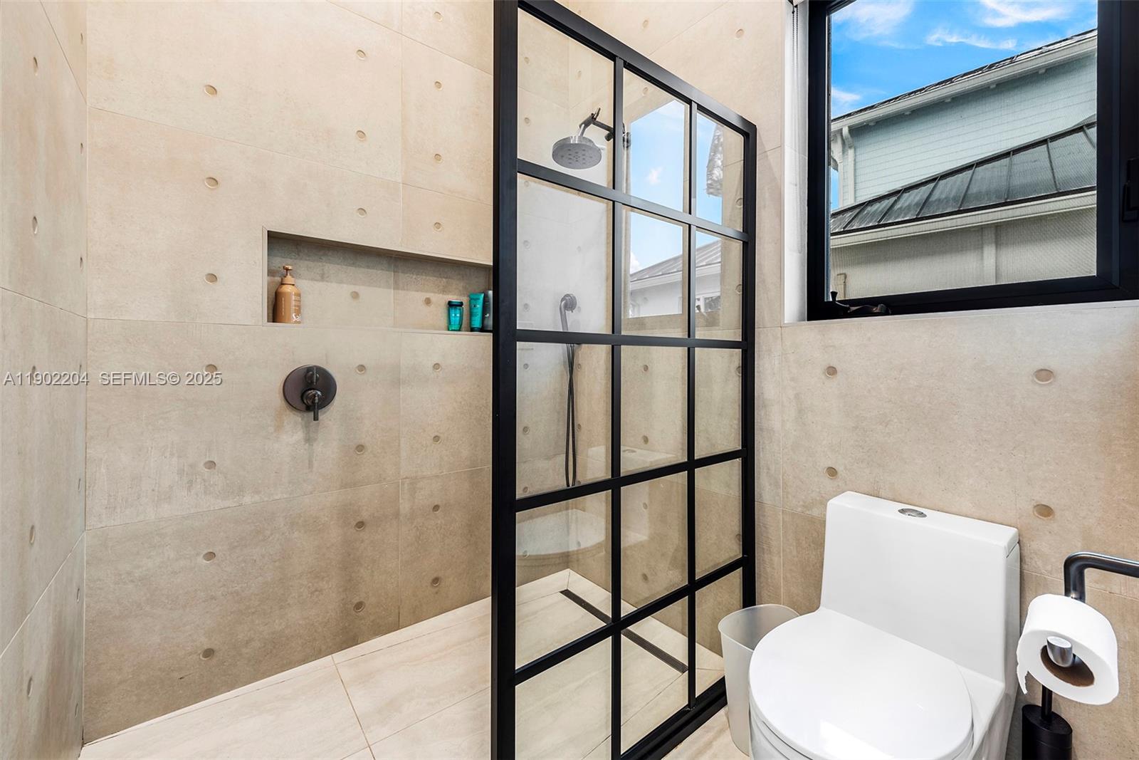 3701 Northeast 26th Avenue, Unit 1 Lighthouse Point, FL 33064 - Photo 40 of 46 a bathroom with a toilet and a shower