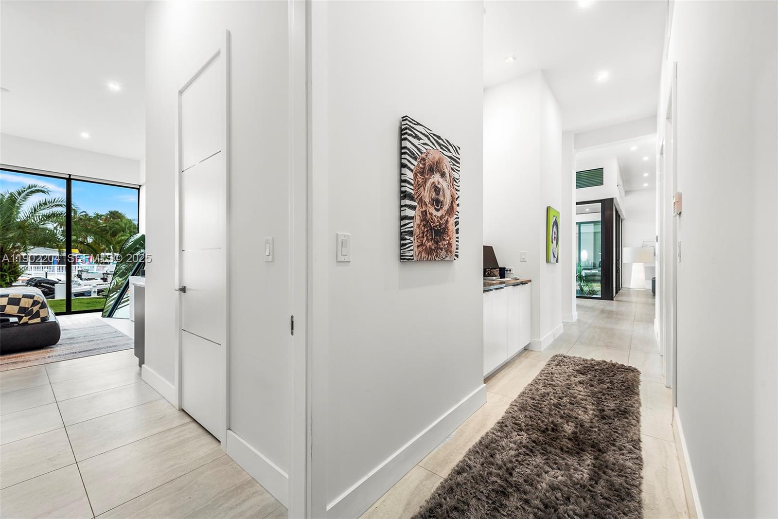3701 Northeast 26th Avenue, Unit 1 Lighthouse Point, FL 33064 - Photo 41 of 46 a hallway with a couch and a view of living room