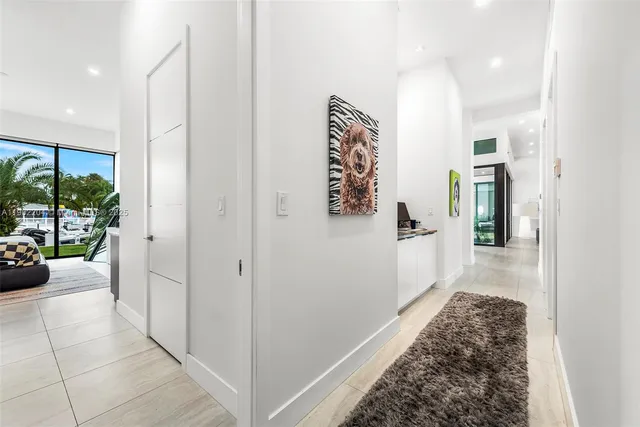 a hallway with a couch and a view of living room