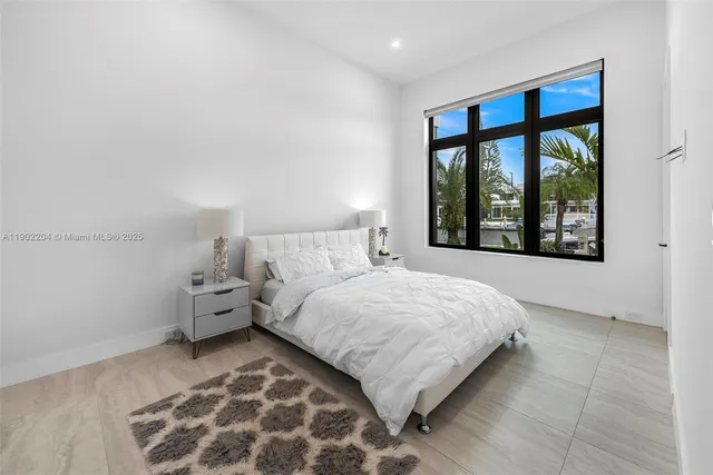 a bedroom with a large bed and a window