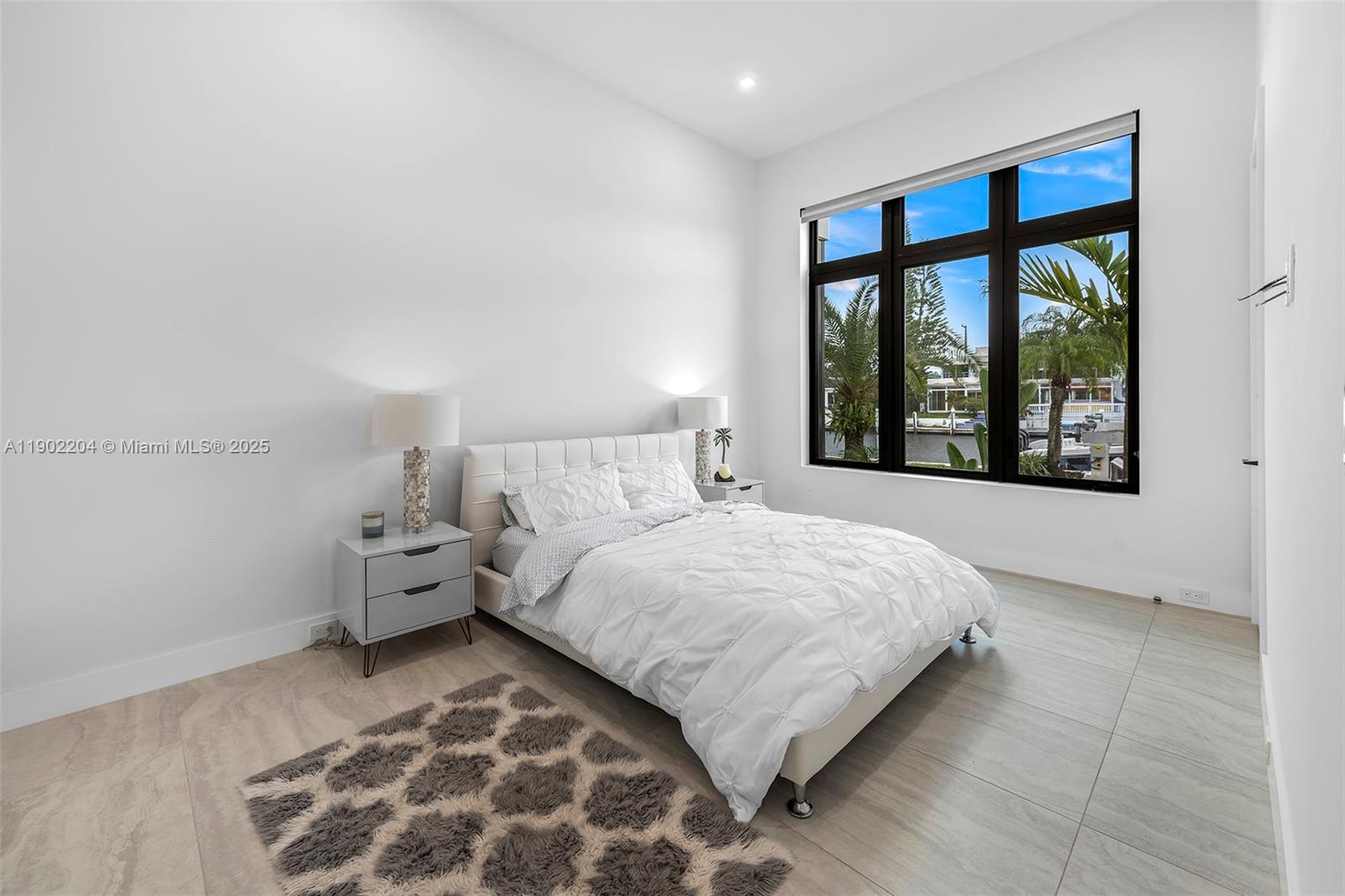 3701 Northeast 26th Avenue, Unit 1 Lighthouse Point, FL 33064 - Photo 42 of 46 a bedroom with a large bed and a window