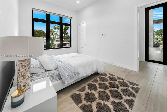 a bedroom with a large bed and a window with outer view