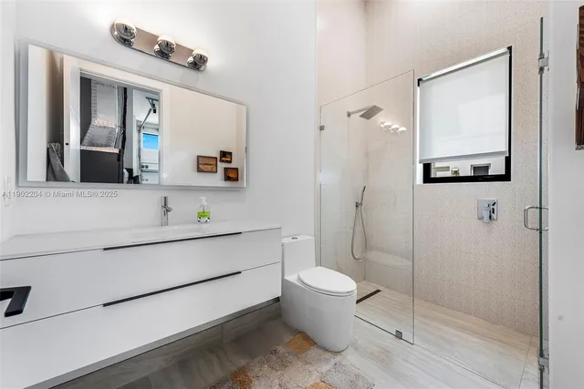 a bathroom with a toilet sink and mirror