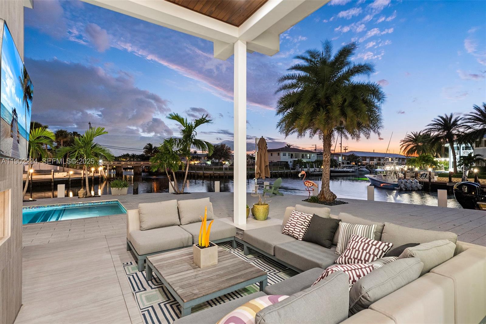 3701 Northeast 26th Avenue, Unit 1 Lighthouse Point, FL 33064 - Photo 8 of 46 a view of a swimming pool and lounge chair