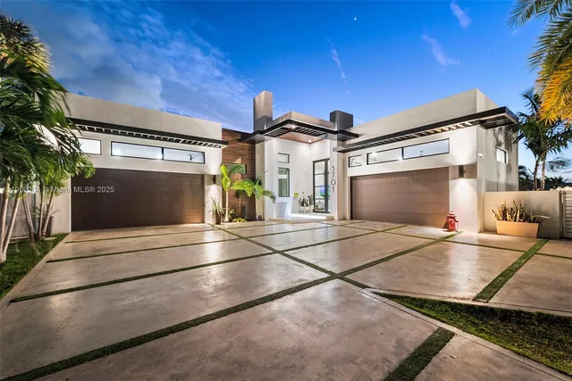 a view of a building with car parked on road