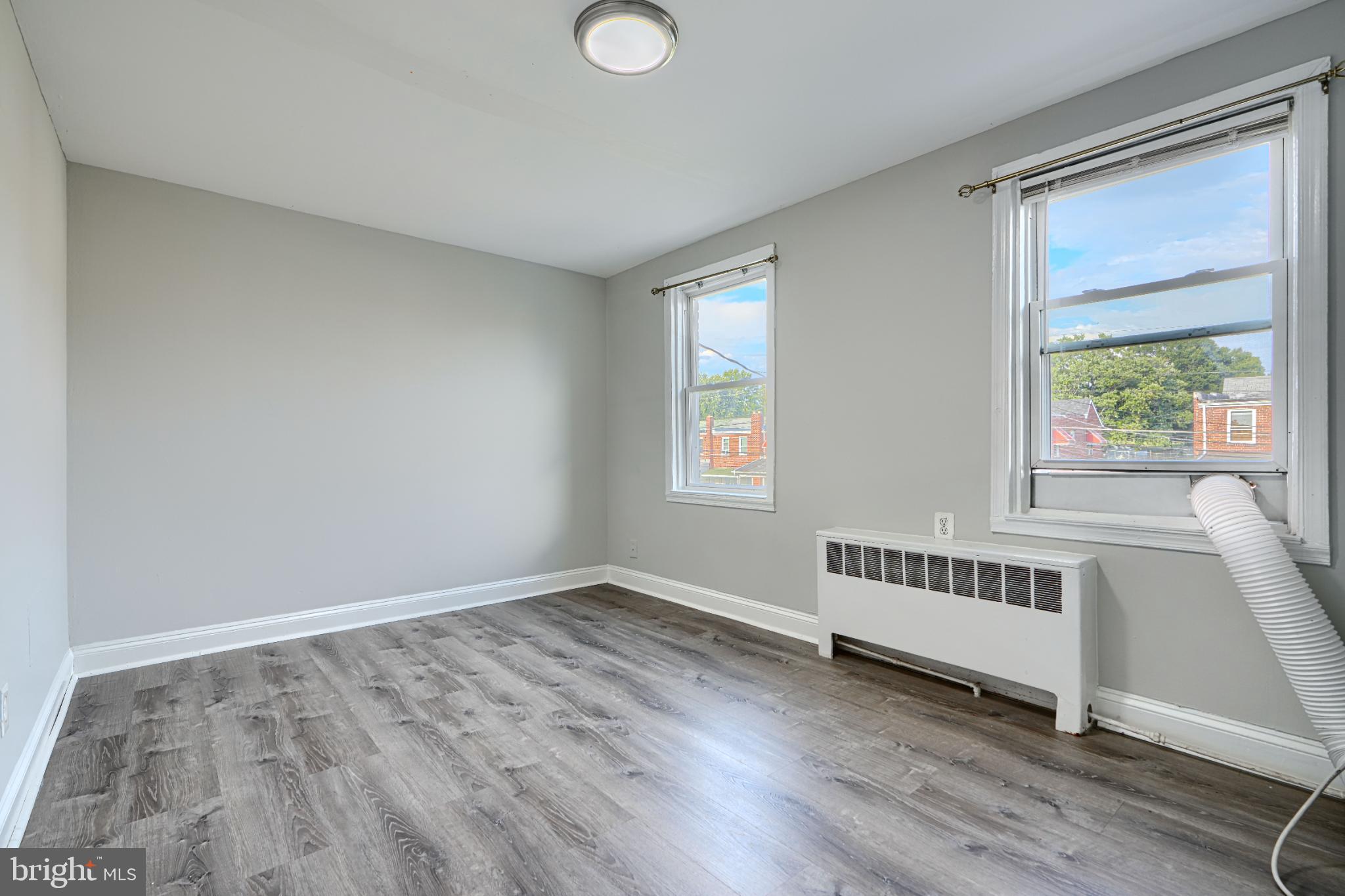 1236 Primrose Avenue Rosedale, MD 21237 - Photo 20 of 39 a view of an empty room with wooden floor and a window