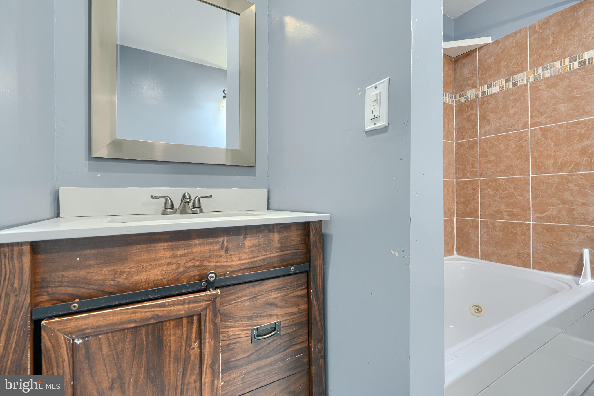 1236 Primrose Avenue Rosedale, MD 21237 - Photo 23 of 39 a bathroom with a sink and a mirror