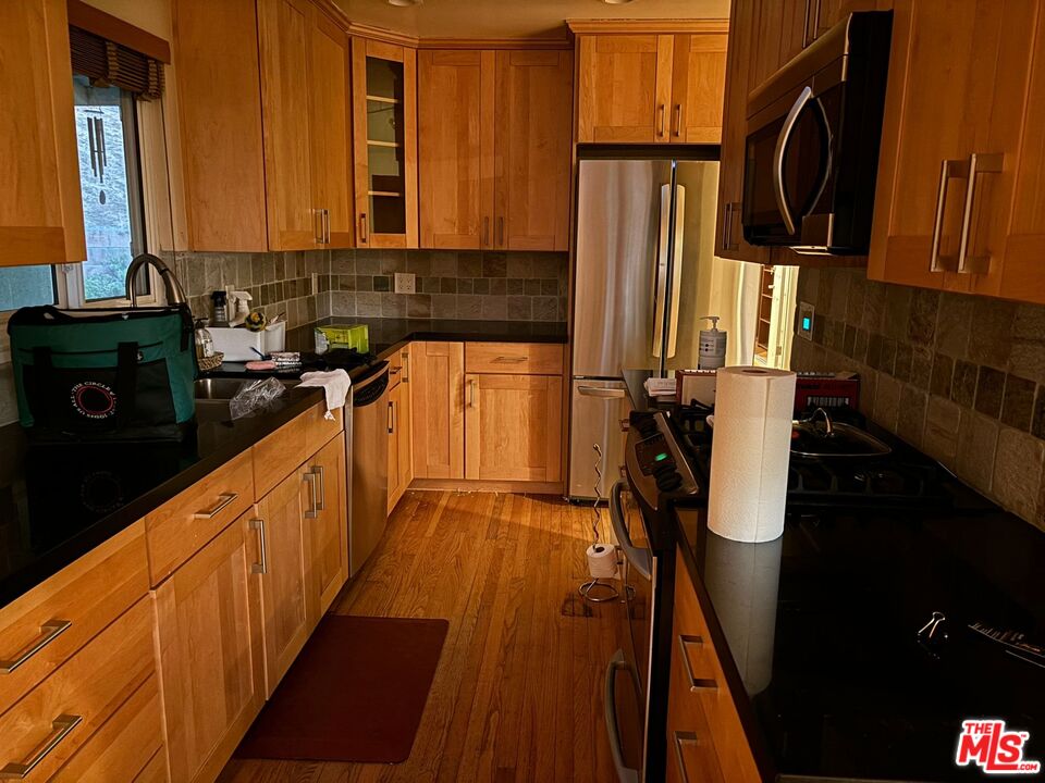 2 Cottage Lane San Carlos, CA 94070 - Photo 4 of 11 a kitchen with blue cabinets a sink a window and stainless steel appliances