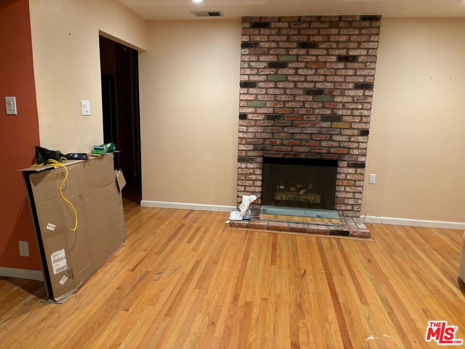 2 Cottage Lane San Carlos, CA 94070 - Photo 6 of 11 a view of empty room with wooden floor and fireplace