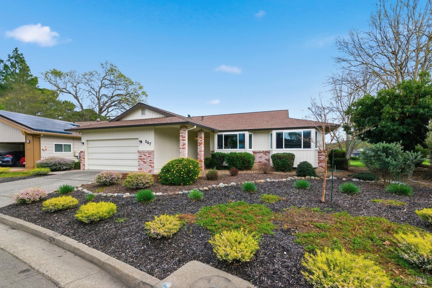a front view of house with yard outdoor seating and green space