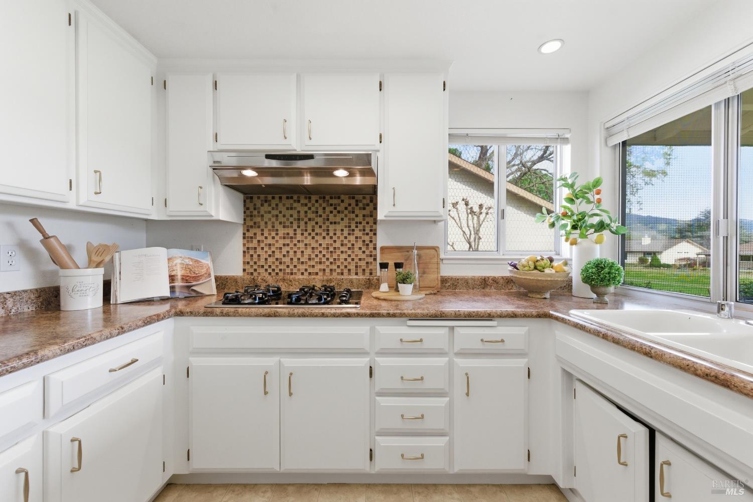 347 Twin Lakes Drive Santa Rosa, CA 95409 - Photo 14 of 47 a kitchen with granite countertop white cabinets and white appliances