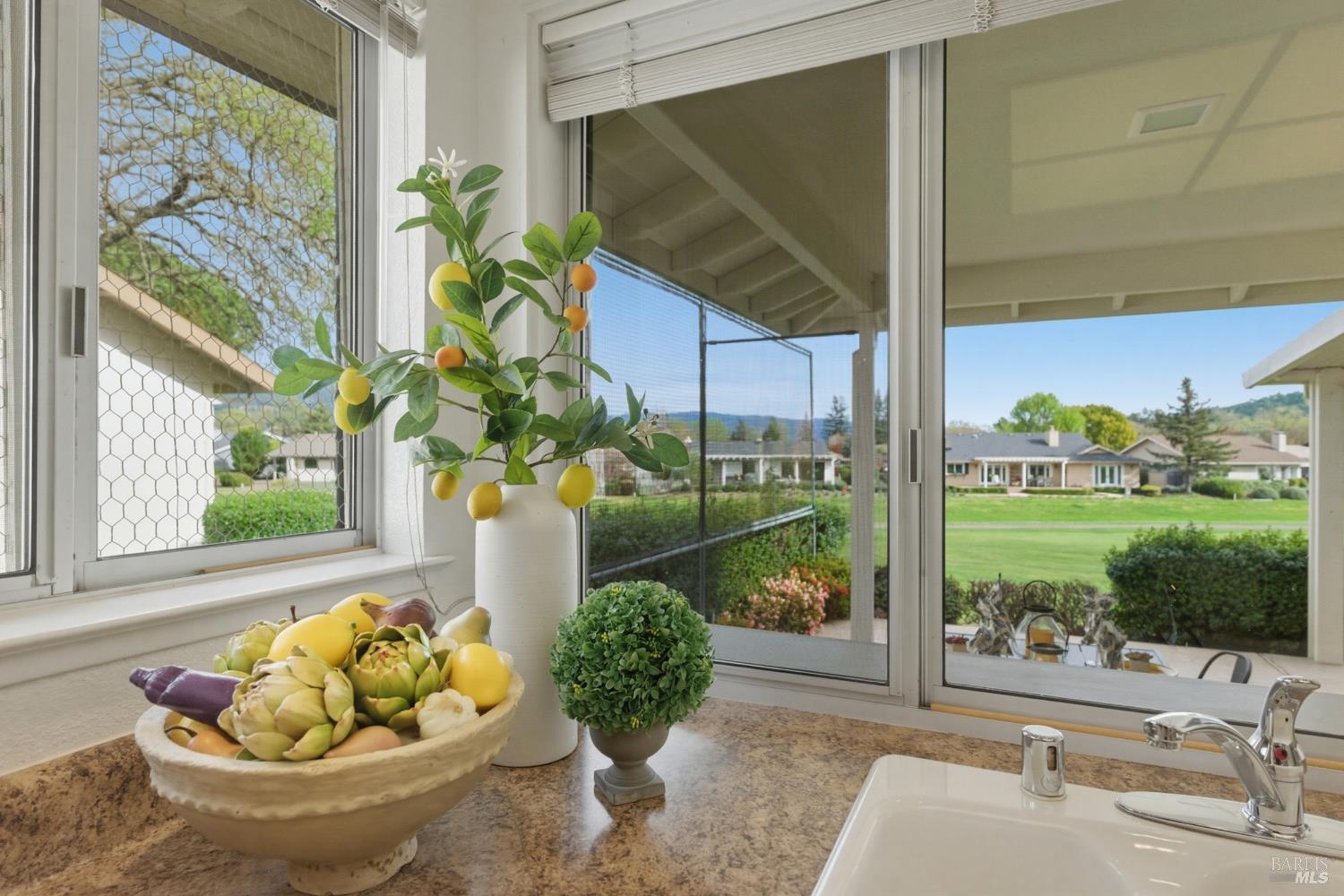 347 Twin Lakes Drive Santa Rosa, CA 95409 - Photo 16 of 47 a vase of flowers sitting on a table with window