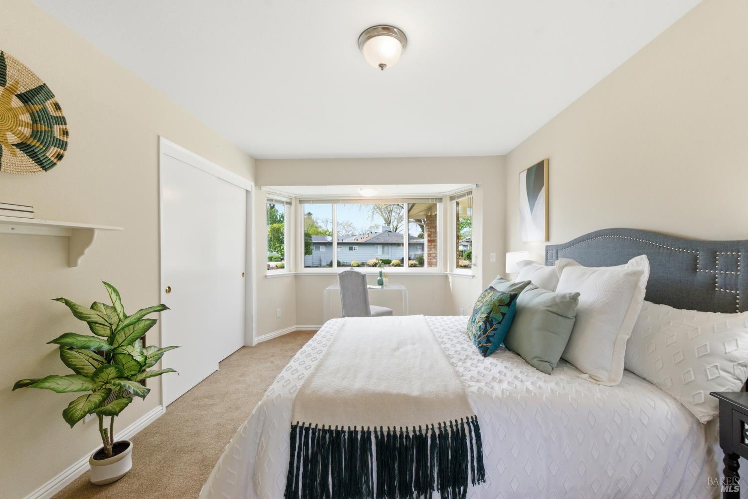 347 Twin Lakes Drive Santa Rosa, CA 95409 - Photo 21 of 47 a bed sitting in a bedroom next to a window with a potted plant