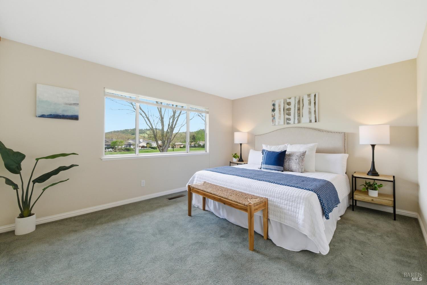 347 Twin Lakes Drive Santa Rosa, CA 95409 - Photo 32 of 47 a spacious bedroom with a bed and a painting on the wall