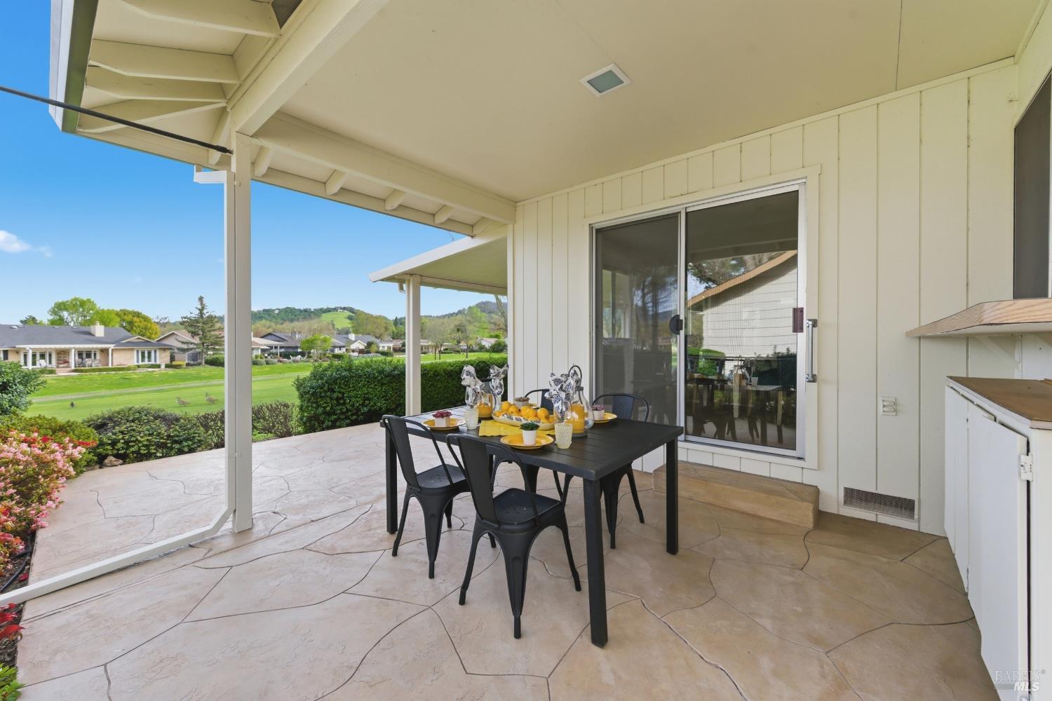 347 Twin Lakes Drive Santa Rosa, CA 95409 - Photo 38 of 47 a view of a patio with a dining table and chairs