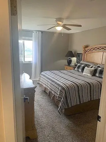 a bedroom with a bed and window