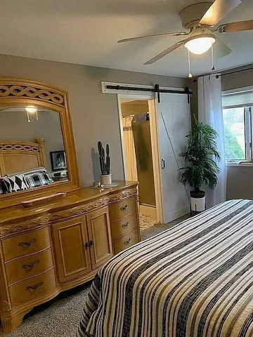 a bedroom with a bed and a mirror