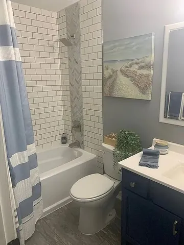 a bathroom with a toilet a sink and bathtub