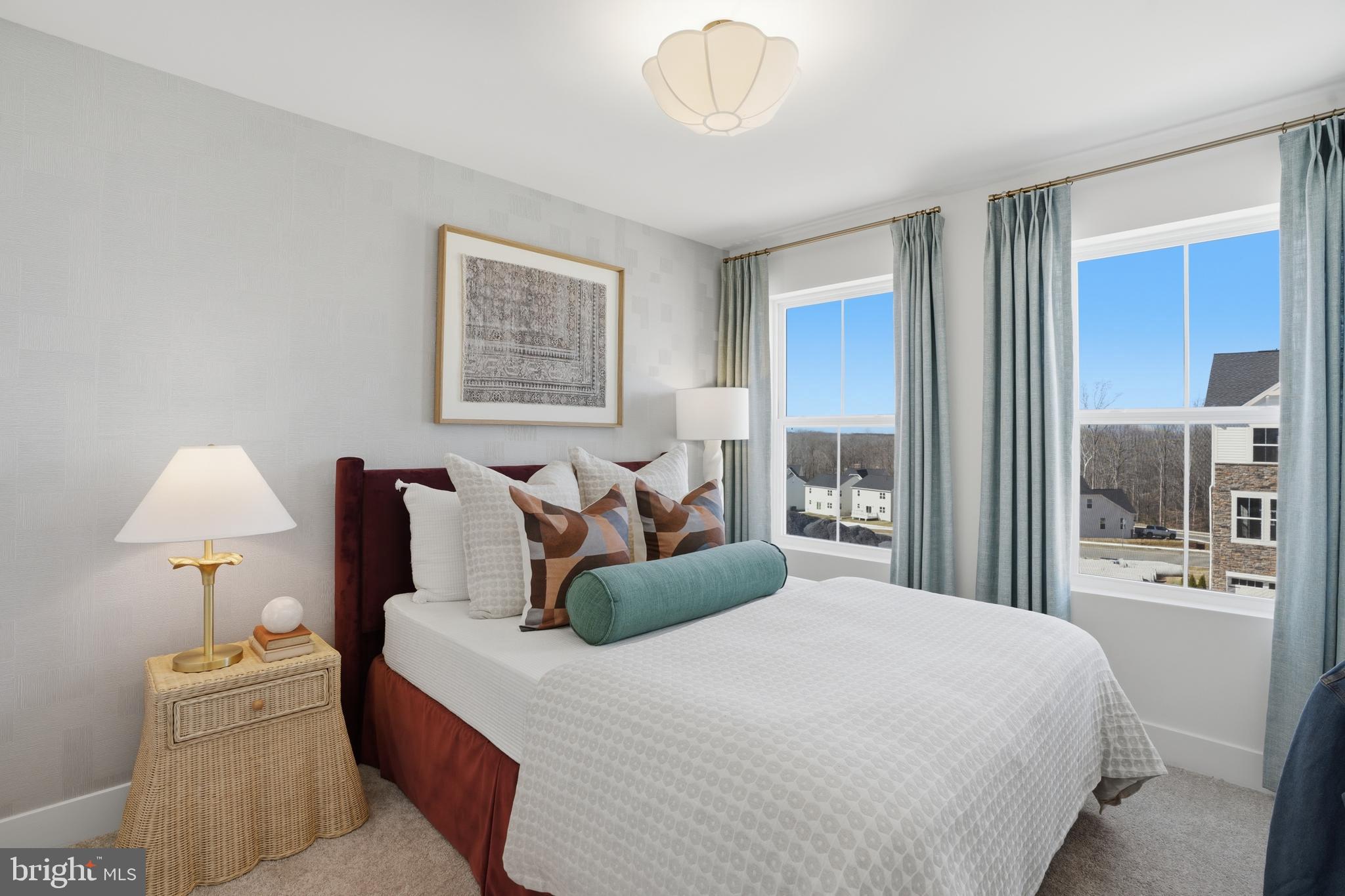 7610 River Reach Road Baltimore, MD 21244 - Photo 12 of 16 a bed room with a bed and a lamp