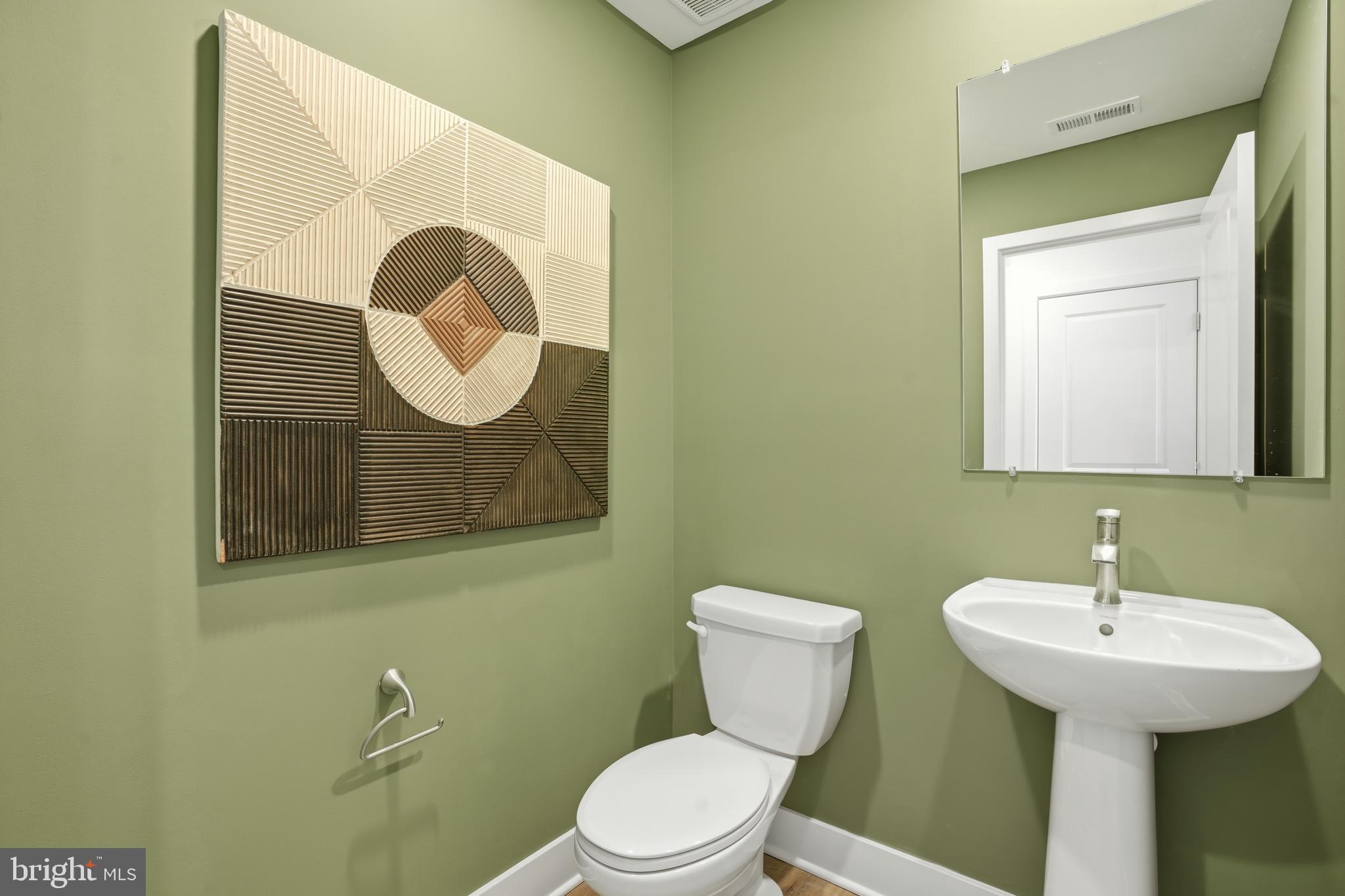 7610 River Reach Road Baltimore, MD 21244 - Photo 8 of 16 a bathroom with a toilet sink and mirror