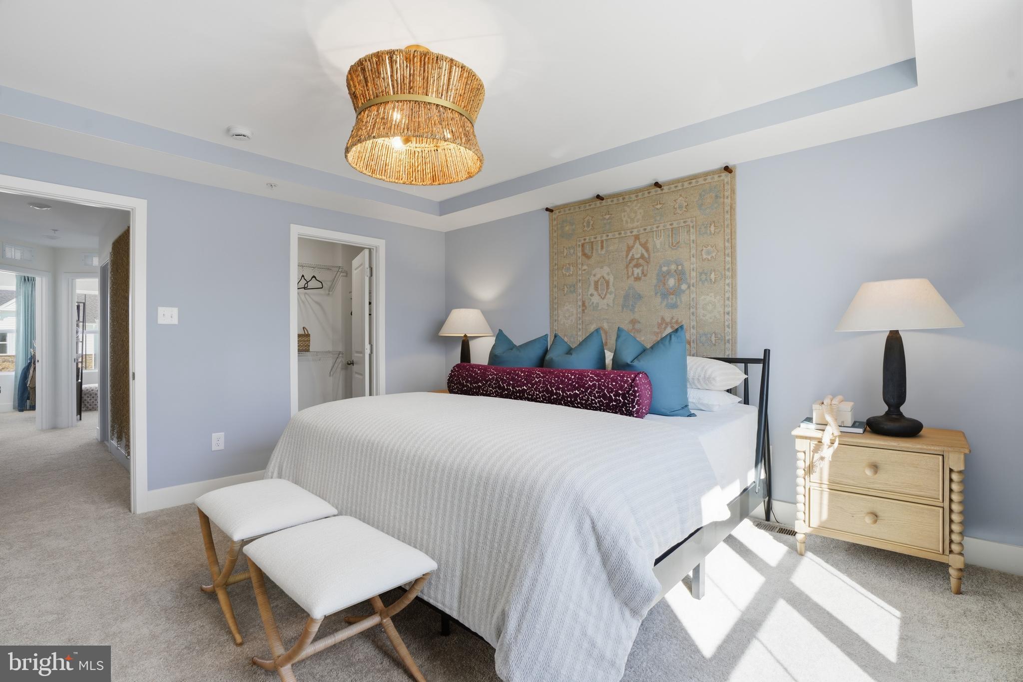 7610 River Reach Road Baltimore, MD 21244 - Photo 10 of 16 a bedroom with a bed and a chandelier