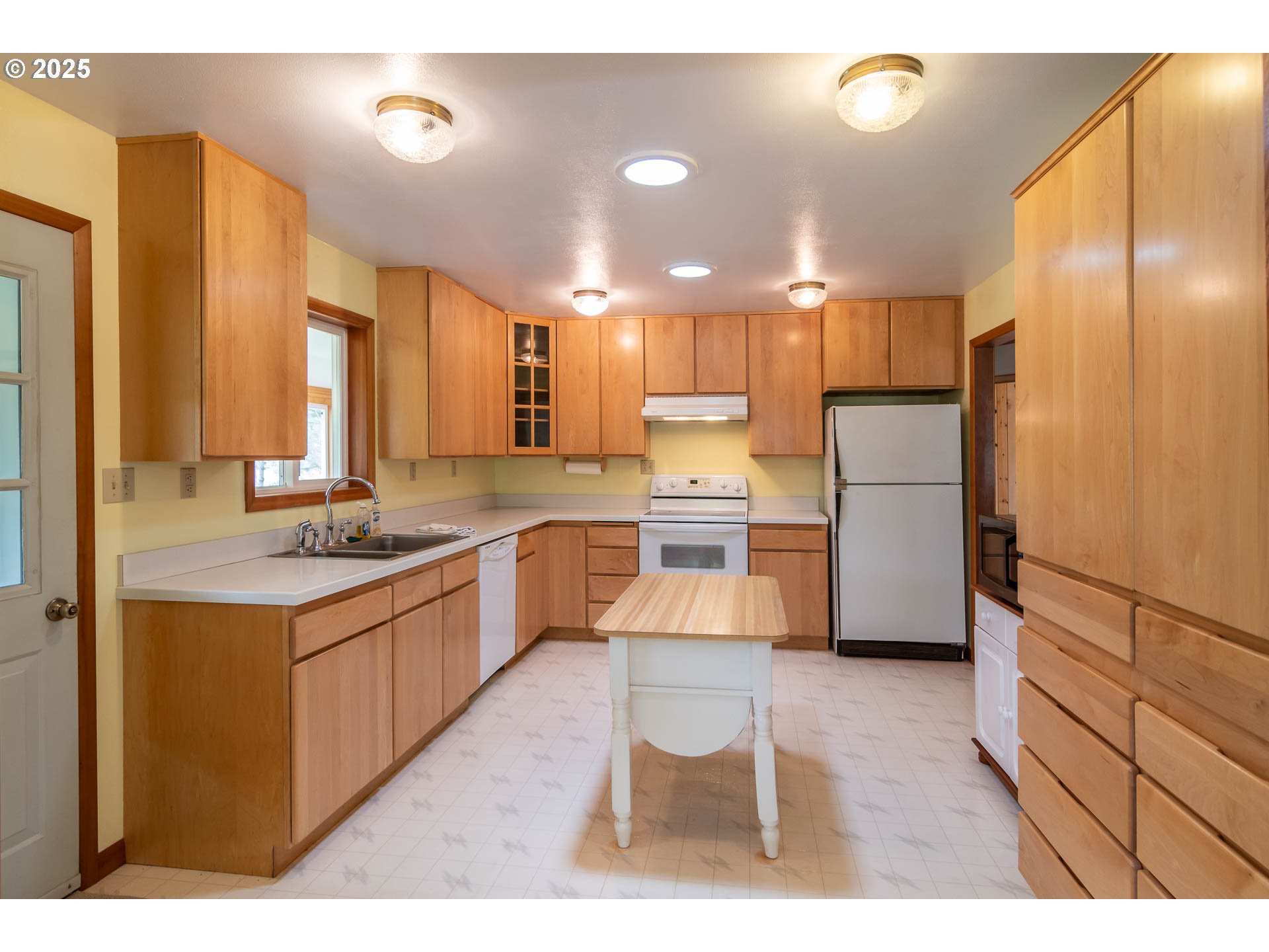 3333 Bullock Road Oakland, OR 97462 - Photo 14 of 48 a large kitchen with a center island wooden floor stainless steel appliances and windows