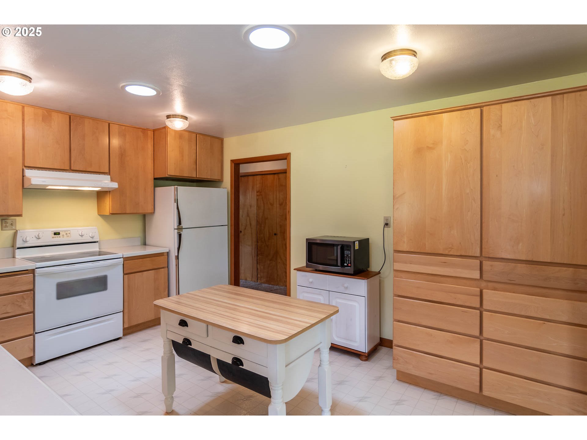 3333 Bullock Road Oakland, OR 97462 - Photo 15 of 48 a kitchen with a refrigerator and white cabinets