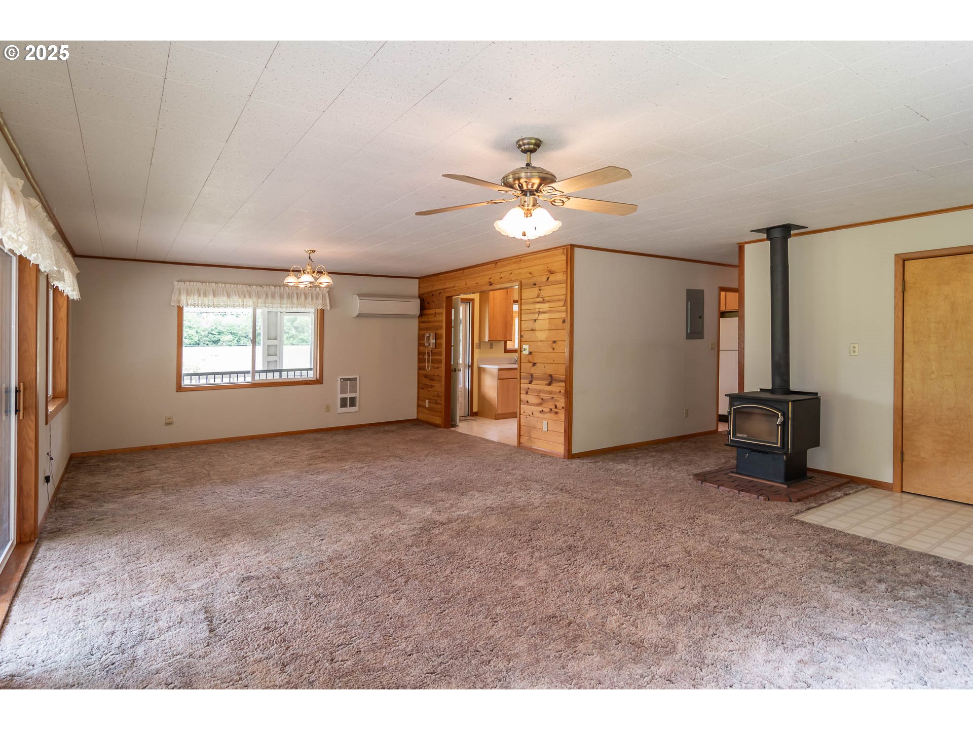3333 Bullock Road Oakland, OR 97462 - Photo 10 of 48 a view of a big room with windows and chandelier fan
