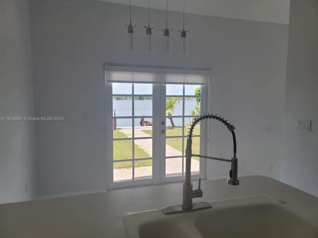 a kitchen with stainless steel appliances a sink and a refrigerator
