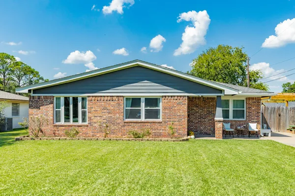 a front view of house with yard and outdoor seating