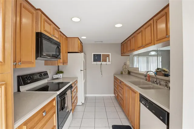 a kitchen that has a sink and a stove