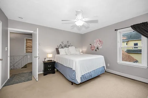 a spacious bedroom with a bed and a window