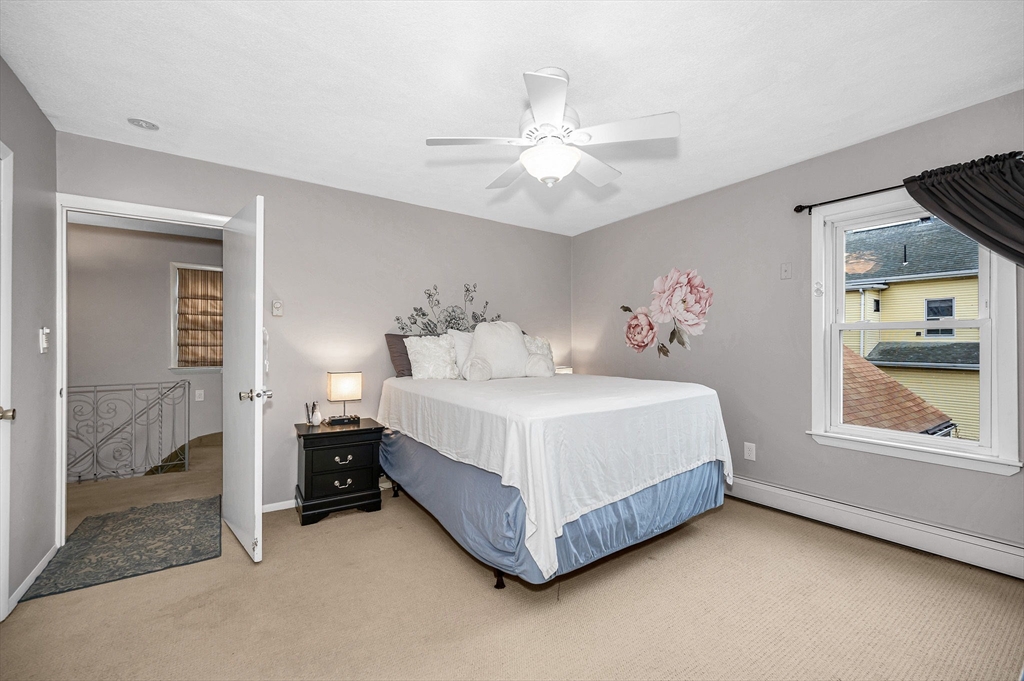 44 Mill Street Revere, MA 02151 - Photo 20 of 36 a spacious bedroom with a bed and a window