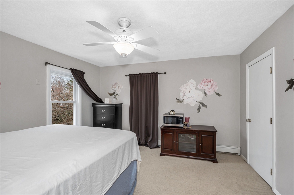 44 Mill Street Revere, MA 02151 - Photo 22 of 36 a bedroom with a bed and a chandelier