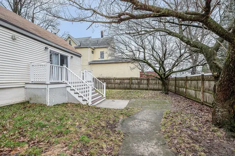 a view of a backyard with a tree