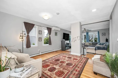 a living room with furniture and a rug