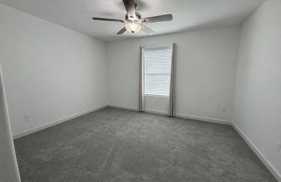 3114 Bolt Street Houston, TX 77051 - Photo 11 of 32 an empty room with a ceiling fan and a window