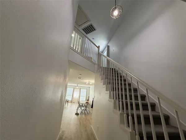a view of entryway and hall with wooden floor