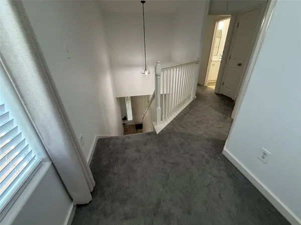 a view of a livingroom with a ceiling fan and a window