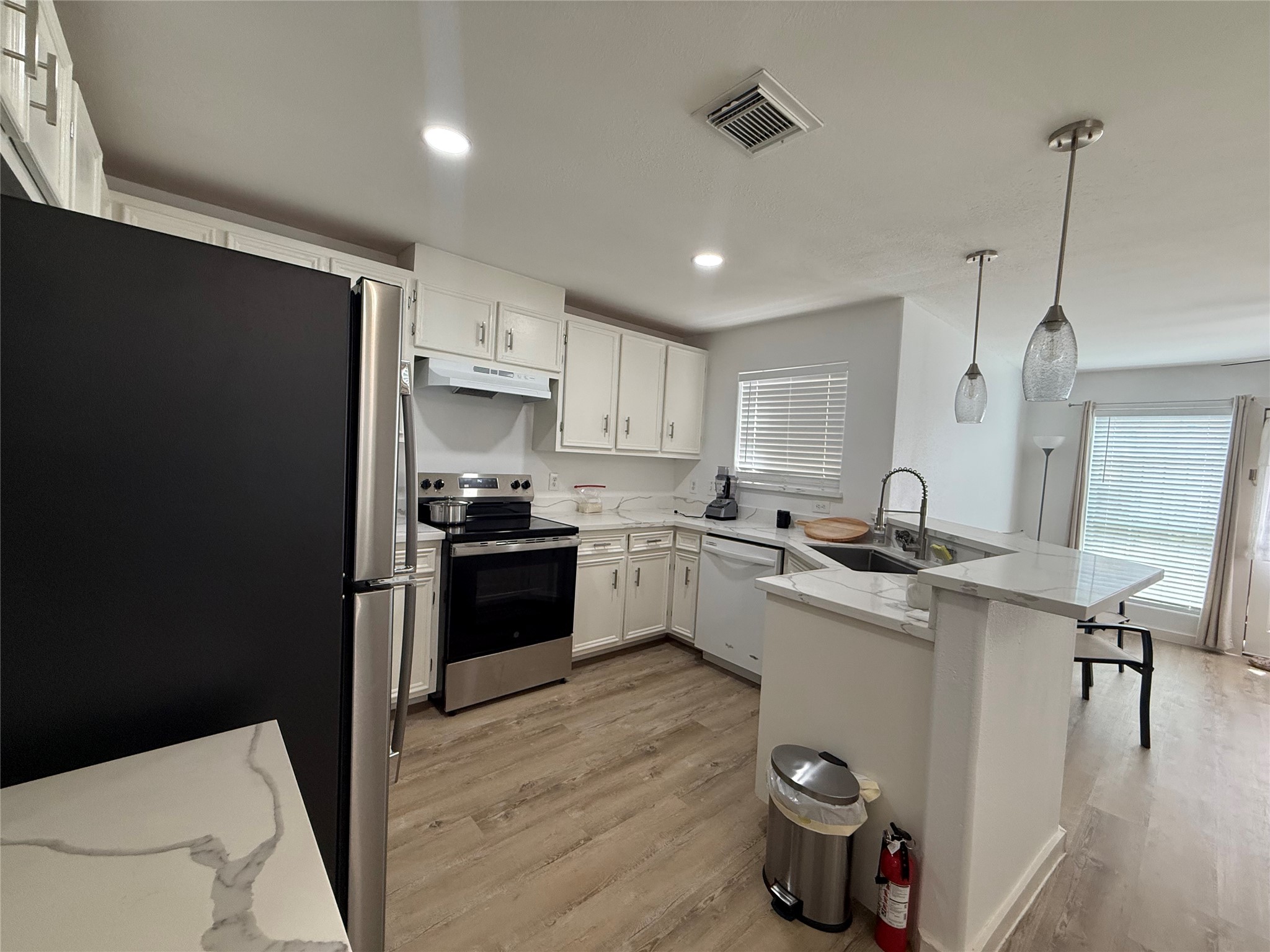 3114 Bolt Street Houston, TX 77051 - Photo 31 of 32 a kitchen with a sink a refrigerator and wooden floor