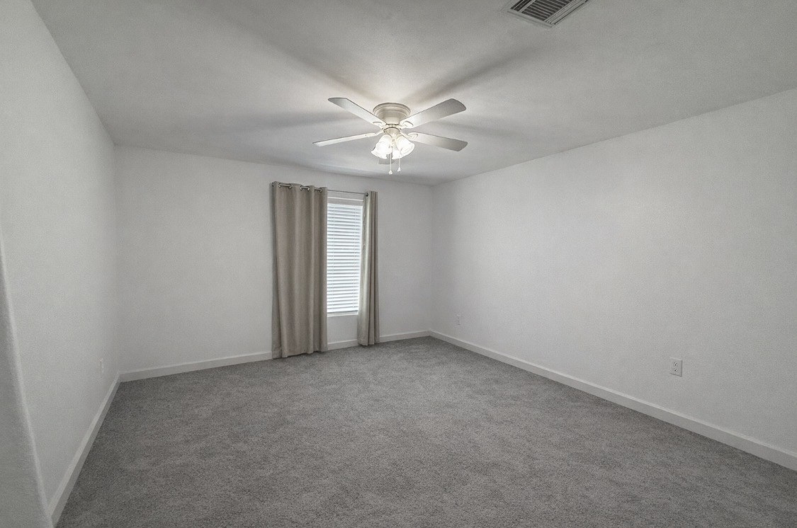 3114 Bolt Street Houston, TX 77051 - Photo 32 of 32 an empty room with windows and fan
