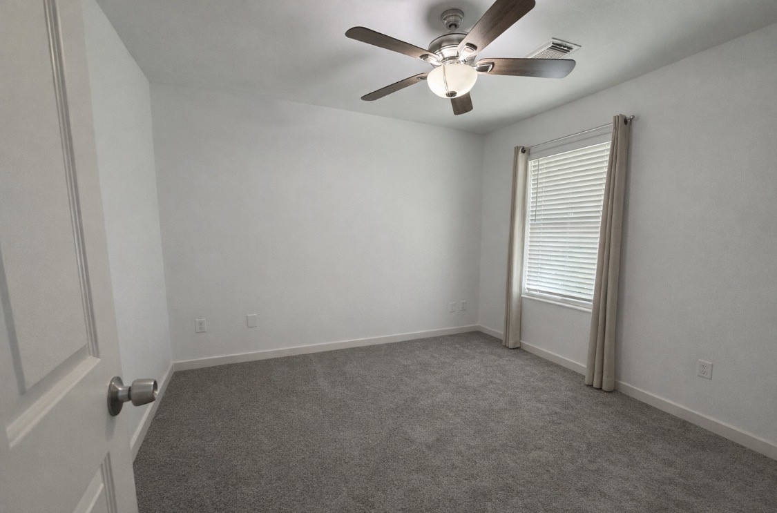 3114 Bolt Street Houston, TX 77051 - Photo 9 of 32 an empty room with a window and a fan