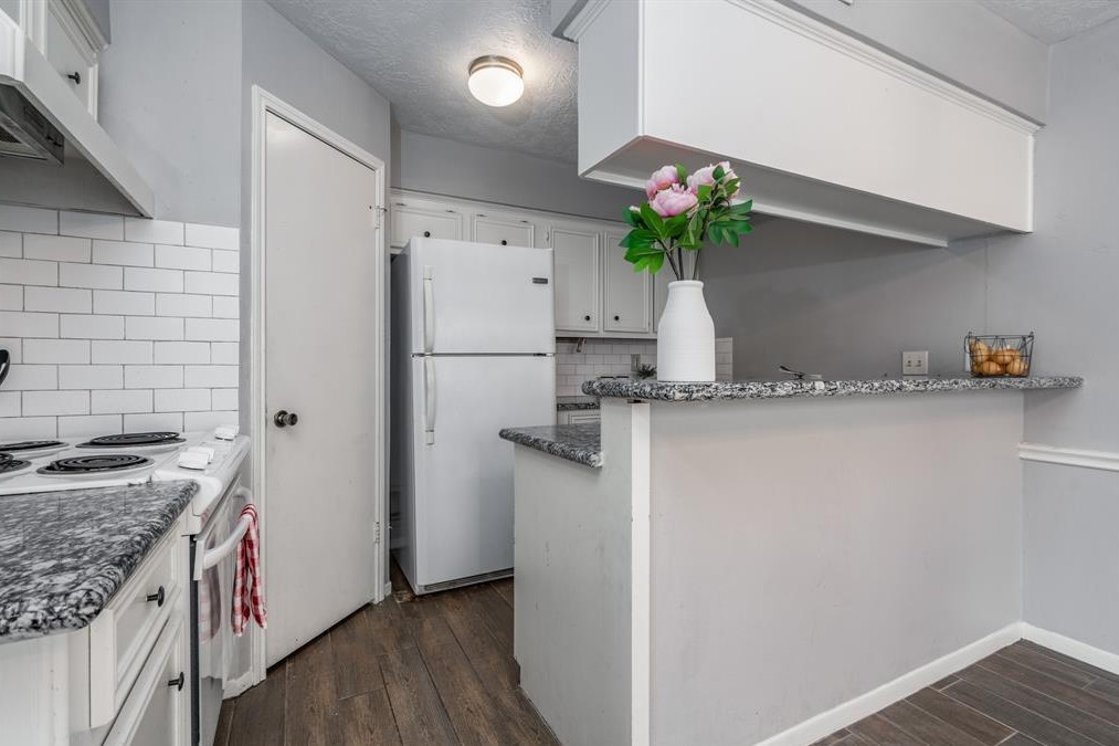 11500 Meadow Lane, Unit 4 Houston, TX 77477 - Photo 11 of 32 a kitchen with a refrigerator and a sink