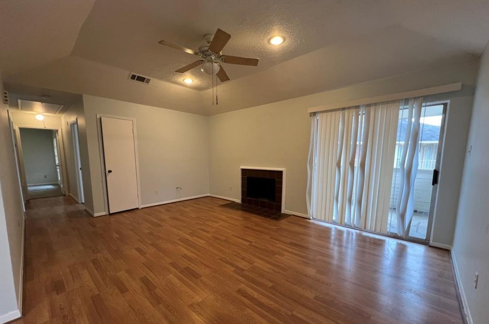11500 Meadow Lane, Unit 4 Houston, TX 77477 - Photo 13 of 32 a view of an empty room with wooden floor and a window