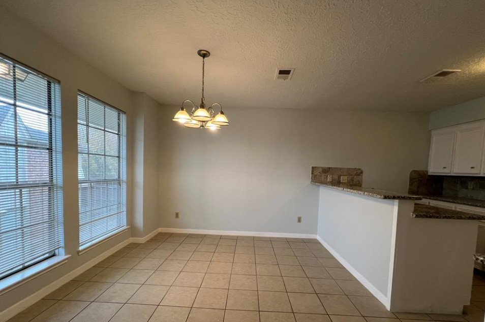 11500 Meadow Lane, Unit 4 Houston, TX 77477 - Photo 14 of 32 a view of a kitchen with a sink dishwasher and wooden floor