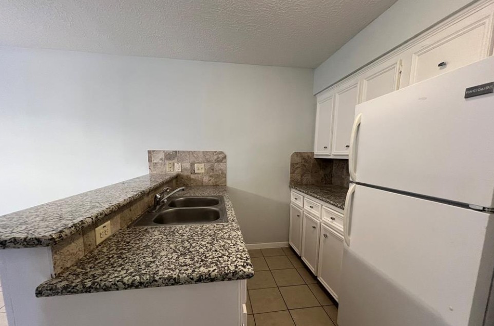11500 Meadow Lane, Unit 4 Houston, TX 77477 - Photo 16 of 32 a kitchen with a refrigerator and a stove