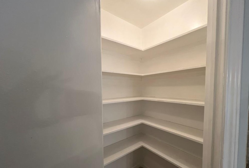 11500 Meadow Lane, Unit 4 Houston, TX 77477 - Photo 17 of 32 a storage room with empty racks